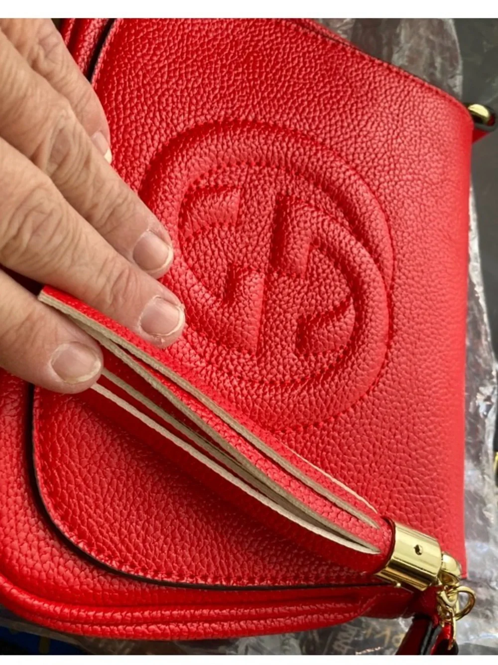Compact Red Crossbody Bag with Tassel Accent